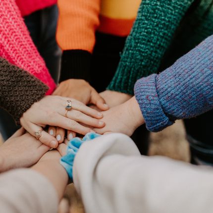 a group of heart church people holding hands